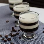 Espresso Jello Shots on a kitchen towel with coffee beans spread on the table