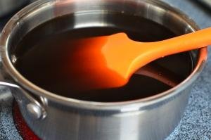 In a saucepan on the stove top coffee, gelatin and sugar are mixed together with a spatula