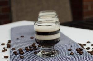 Espresso Jello Shots on a kitchen towel with coffee beans spread on the table