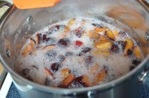 Prunes bing boiled in a pot over the stove top