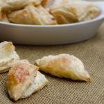Puff Pastry Cheese Turnovers in a bowl and on the table