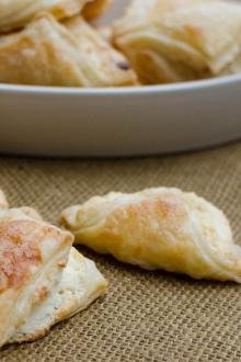 Puff Pastry Cheese Turnovers in a bowl and on the table