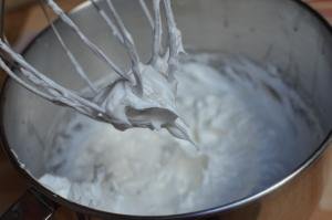 Eggs white and sugar beat together in a KitchenAid mixer