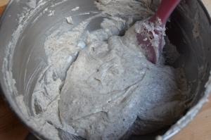 Dough mixture being mixed together with a spatula in a large bowl