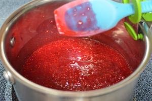 Raspberries and gelatin mixture in a pot over the stove top