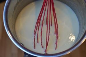 Cream mixture being whisked together in a bowl
