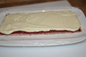Layers laid out on a plate dough, raspberry jam, and cream