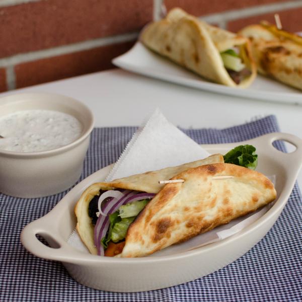 Gyro and Tzatziki Sauce on a table