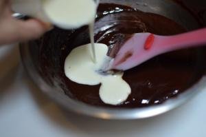 whipping cream and gelatin added to the chocolate mixture in a bowl