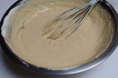 Sour cream and dulce de leche whisked together in a bowl