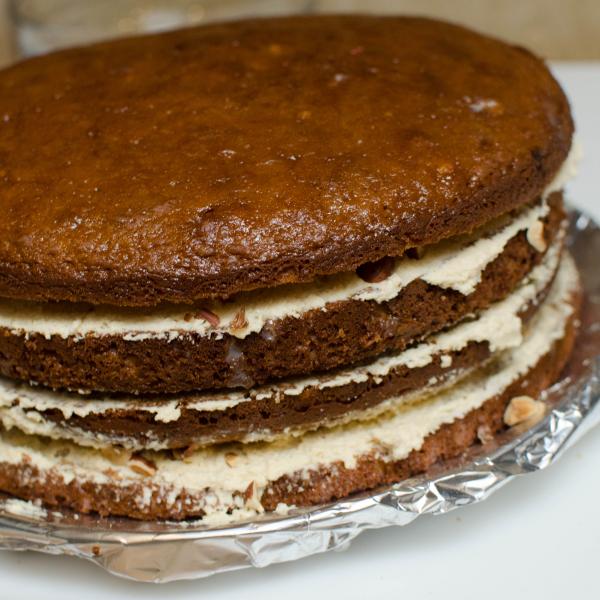 Sponge cake layer with cream and hazelnut pieces between each layer