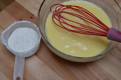 Eggs and flour being whisked together in a bowl