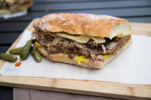 Cuban Pork Sandwich on a cutting board lined with parchment paper
