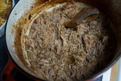 Pork pulled apart in a dutch iron oven