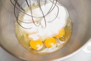 Eggs and sugar being beat together in a KitchenAid mixer