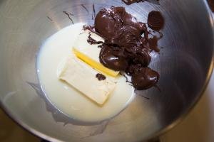 Butter, chocolate mixture and condensed milk in a mixing bowl