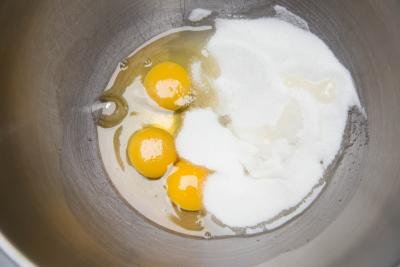 3 eggs and sugar in a mixing bowl