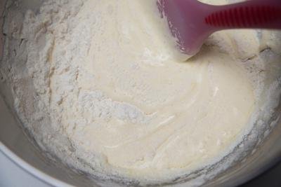 Flour being mixed into the batter with a spatula