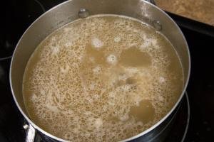 Water in a pot being boiled with pieces of meat and better then beef bullion