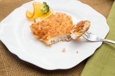 Panko Fish on a plate with a slice of orange