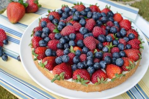 A full fruit tart on a plate