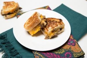 Mushroom and Cheese Sandwich cut in half on a plate