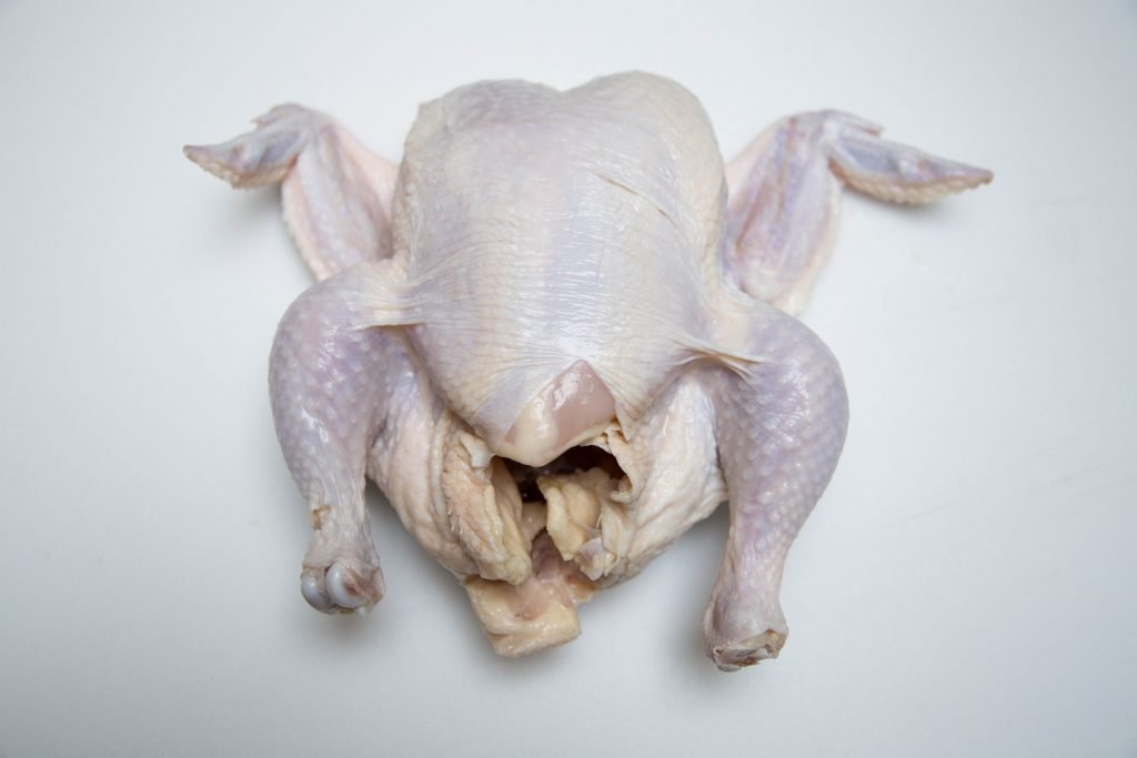 A whole chicken on a table