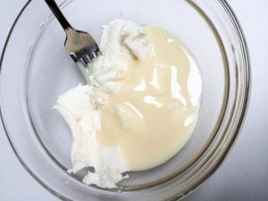 Ricotta cheese and condensed milk in a bowl