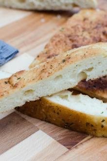 Easy Focaccia Bread cut into long thin slices on a cutting board