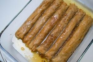 A baking pan filled with rolled baklava
