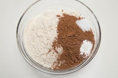 Flour and cocoa being mixed together in a bowl