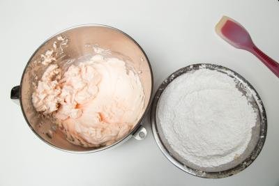 Mixing bowl with colored, beat egg whites and sugar and bowl with the sifted powdered sugar and almond flour