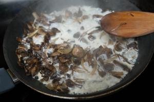Cream added to the skillet with mushrooms and onions
