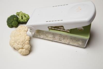 Cauliflower being diced using a plastic vegetable dicer