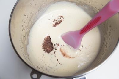 Ground up chocolate being combined with whisked eggs and honey