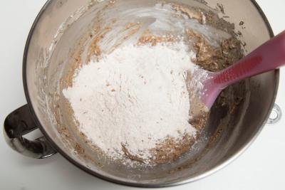 Wet ingredients being combined with flour mixture in a mixing bowl