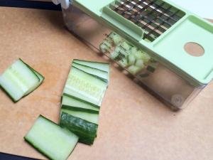 Cucumbers being diced using a plastic veggie dicer