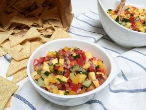 Mango Salsa in a bowl with chips next to the bowl