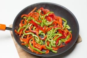 Sliced bell peppers in a skillet