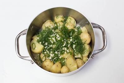 Potatoes in a pot with scallions, garlic and dill