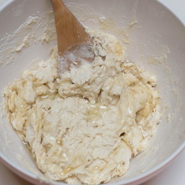 Oil added into the pizza dough mixture in a bowl