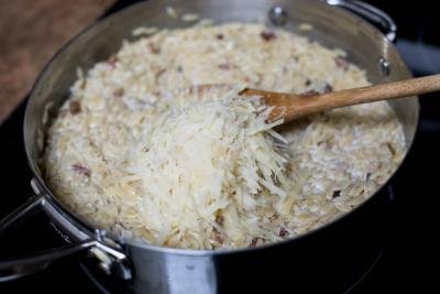 Parmesan cheese grated into the deep skillet with the orzo pasta