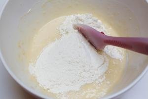 Flour and liquid mixture being combined with a spatula