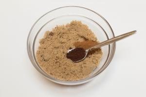 Instant coffee, cinnamon and brown sugar being combined in on bowl