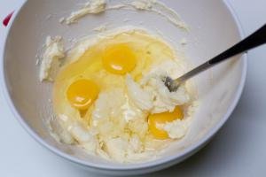 3 eggs added into sugar and butter mixture in the bowl