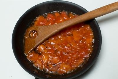 Diced tomatoes and oil in a skillet