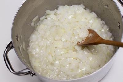 diced onions being sautéed in a large pot