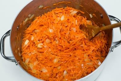 Shredded carrots added to the large pot with onions
