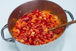 Diced peppers added to the large pot with shredded carrots and onions