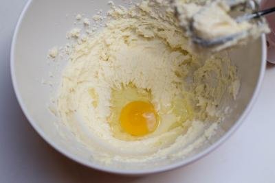 An egg added to the butter and sugar mixture